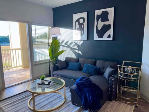 Indulge in comfort and style in our inviting living room. With a cozy blue couch, modern design, and all the comforts of home, it's the perfect space to relax and enjoy a quiet evening during your stay.