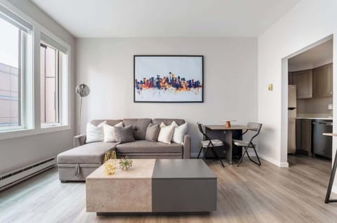 Couch, coffee table and dining table in living room.