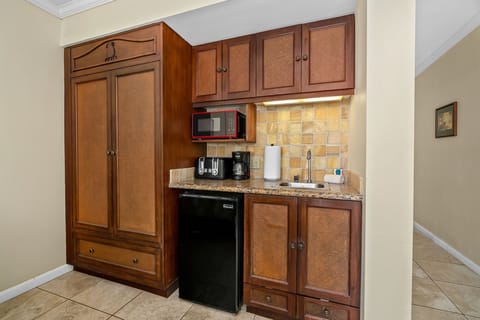 Your compact kitchenette features beautiful wooden cabinetry, granite counters, and everything needed for easy meal prep and coffee breaks.