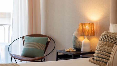 A comfy corner of the bedroom with natural light and elegant decor. #RelaxingStay #ModernLiving