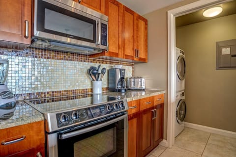 Fully equipped kitchen with modern appliances and in-unit laundry convenience. HKK-926