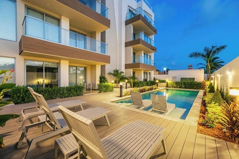 Soak in the serene glow of the pool under the evening lights — a magical way to unwind and enjoy your night.