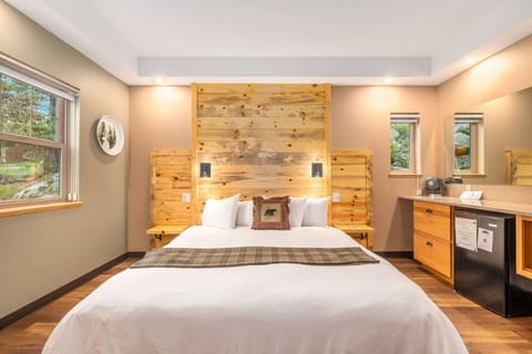 Cozy pine accent wall behind the king bed