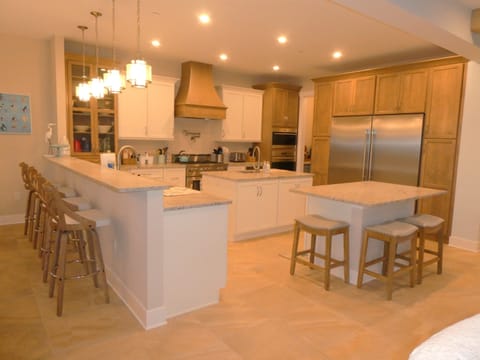 Well stock kitchen with 2 islands and counter seating for 6