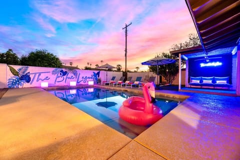 Resort-style pool illuminated by vibrant evening colors, creating the perfect setting for a relaxing Scottsdale night.