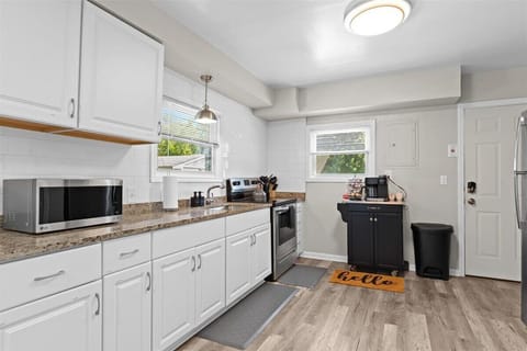Fully stocked kitchen with modern appliances and cookware