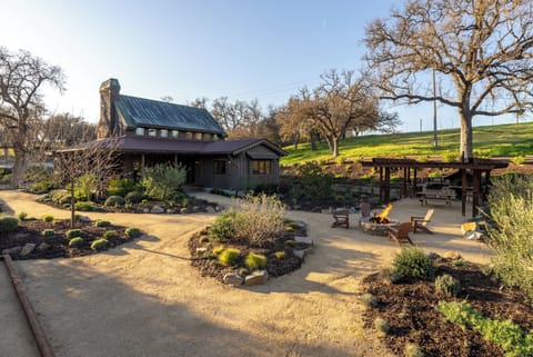 Experience the tranquillity of the countryside in this gorgeous private estate. The rustic wood house with a steep metal roof overlooks the beautifully landscaped grounds.