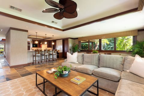 Open-concept living room with garden views and comfortable, upscale seating.