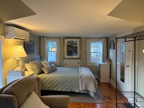 Queen-size bed w/ thick foam mattress, comfy chairs, pivoting tv & ample storage