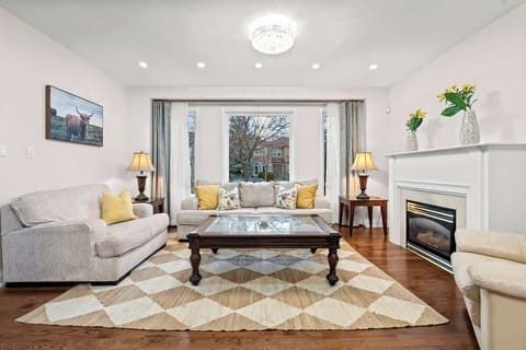 Unwind in this bright, open-concept living room with a cozy fireplace.