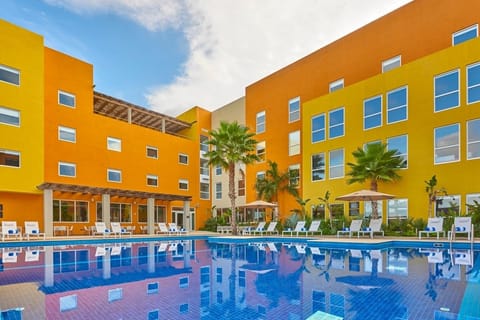 Dive into a vibrant courtyard pool with sunny reflections.