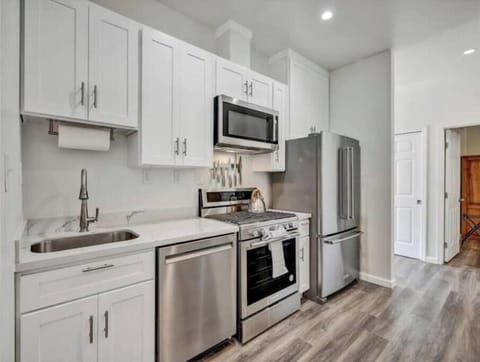 Kitchen with quality appliances, gas stove, dishwasher & rolling prep cart.