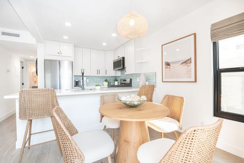 Cozy dining space with seating for four, complemented by additional counter seating for two
                