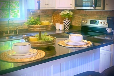 The eat in kitchen serves six with fully stocked kitchen amenities.