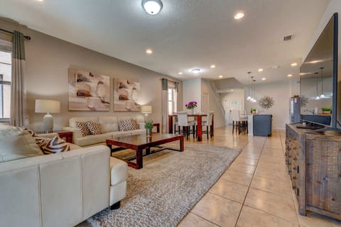 Spacious living area with comfortable seating and a dining table in a modern open floor plan.