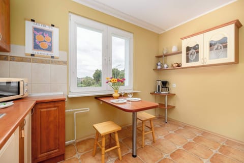 A kitchen with a window and dining area allows you to prepare meals comfortably and enjoy them in natural light.