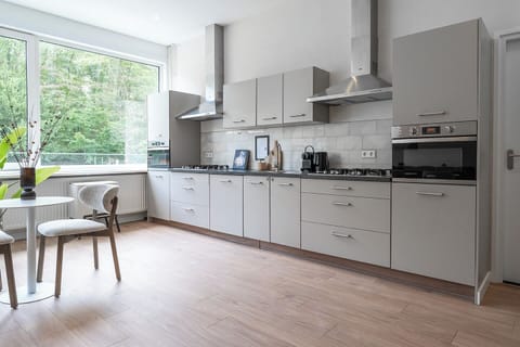 Cook, dine, and relax in this inviting shared kitchen and lounge area.