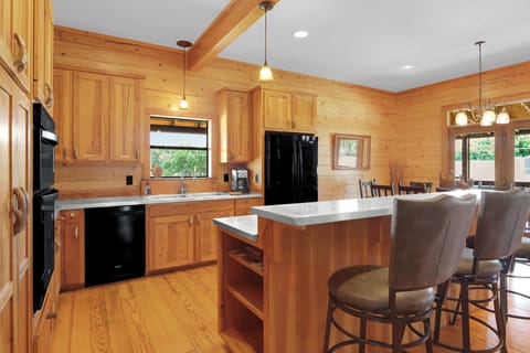 Full kitchen with center island and bar seating