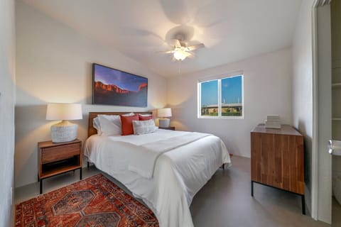 Bedroom 2 with cozy queen bed, modern furniture, ceiling fan, and closet