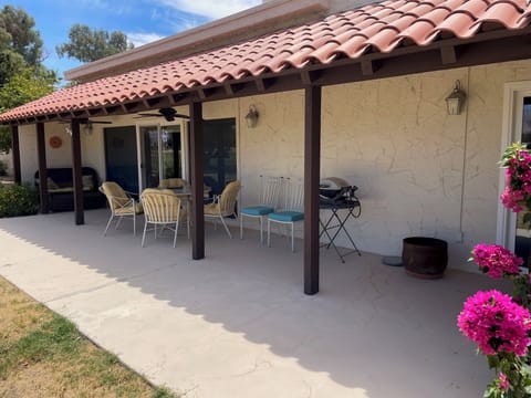 back patio with a small grill and plenty of seating