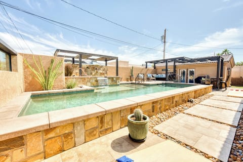 Private backyard with pool, spa, firepit, BBQ, sundeck and covered patio.