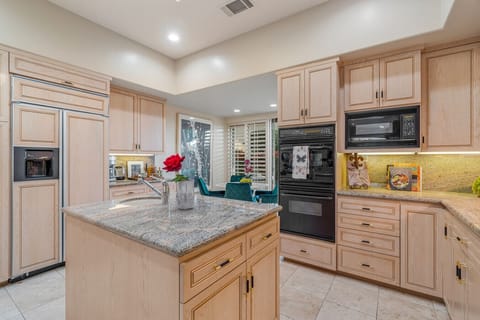 Chef’s Kitchen – Granite counters and custom cabinetry with premium appliances.