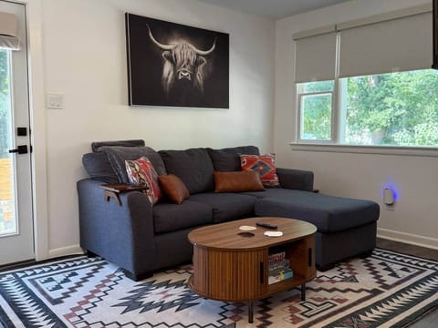 This living room is pure Southwest-cozy. Stretch out on the deep sectional, sip something warm, and admire that handsome highland cow watching over you. Between the bold rug, cozy pillows, and soft light, you may never want to leave this corner.