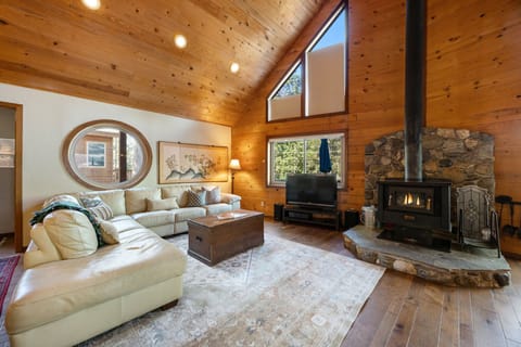 Cozy great room w/ large sofa and wood stove
