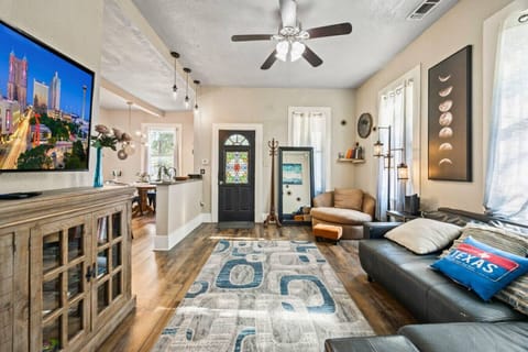 Spacious & Stylish – Bright, airy, and beautifully decorated living space with ceiling fan and cozy seating.