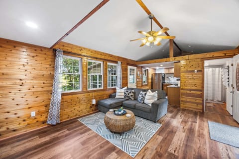Living Room 1: Cozy up in our charming living room! With warm wood paneling, comfortable seating, and plenty of natural light, it's the perfect spot to relax, watch a movie, or enjoy good company after a day of adventures.