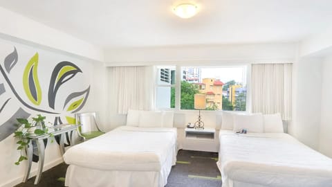 Wake up refreshed in sunlit comfort with two inviting beds.