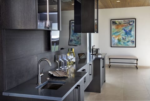 Just under the massive living room TV is the wet bar with sink, ice maker and fridge. It makes drink refills when you're lounging in the hot tub a breeze!