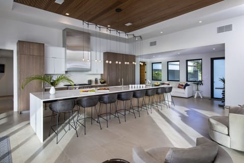 State of the art kitchen with 10 surrounding barstools for entertaining 