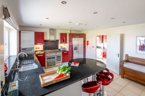 Ground floor:  A well-equipped fitted kitchen with adjoining utility