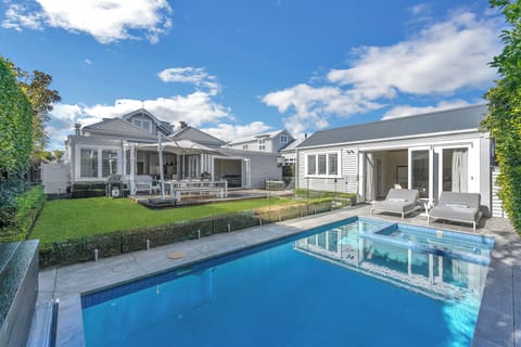 Outdoor entertaining area featuring a swimming pool with a spa.