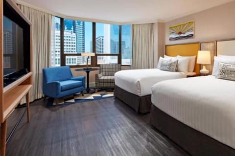 Wake up to skyline views from a spacious, sunlit room.