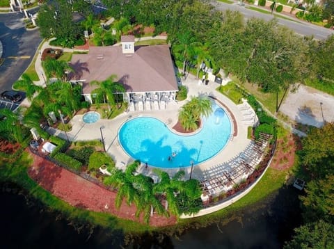 Stunning aerial view of the resort-style pool surrounded by lush greenery