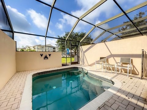 Relax by your private screened pool with sunny views and loungers.