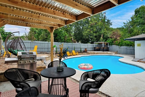 Relax poolside under the shaded patio with BBQ and dining space