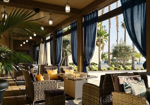 Lounge under shaded drapes in an airy, resort-style porch.