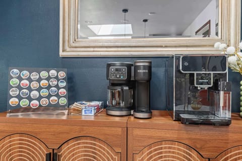 Fully stocked coffee bar with Keurig, drip coffee maker, and a wide selection of pods.