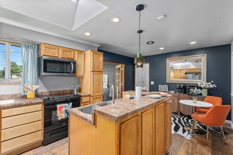 Chic seating area with orange accent chairs and modern décor in stylish Westminster Airbnb.