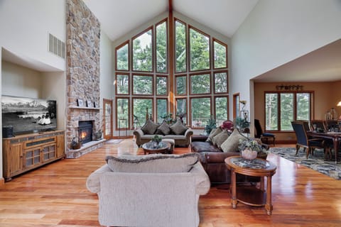 Wall of windows, cozy fire, and vaulted ceilings—this great room is the heart of the home and the perfect gathering space for your group getaway.