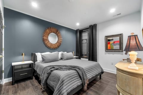 Primary bedroom with king bed and black out curtains
