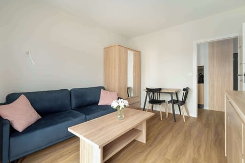 The stylish bedroom includes a comfortable sofa bed and a wardrobe.