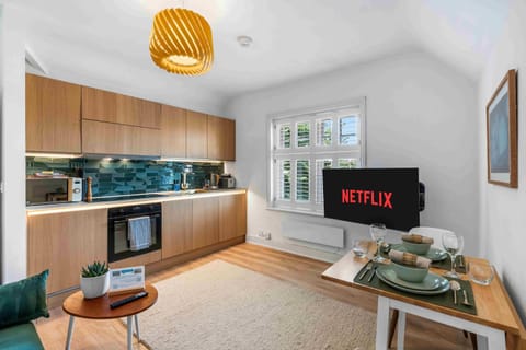 Sleek, fully equipped kitchen with contemporary fittings, light cabinetry, and ample workspace for cooking.