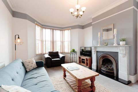 Comfortable living room with cosy sofas, books, and board games