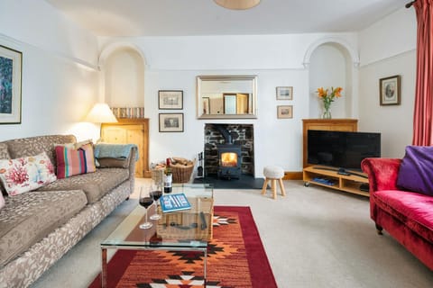Large sofa, glass coffee table on top of rug