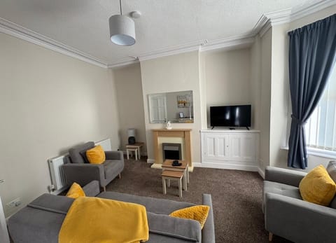 The stylish living area benefitting from a Smart TV with Netflix and a comfortable sofa.