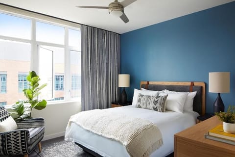 Unwind in a sunlit bedroom with crisp linens and calm tones.